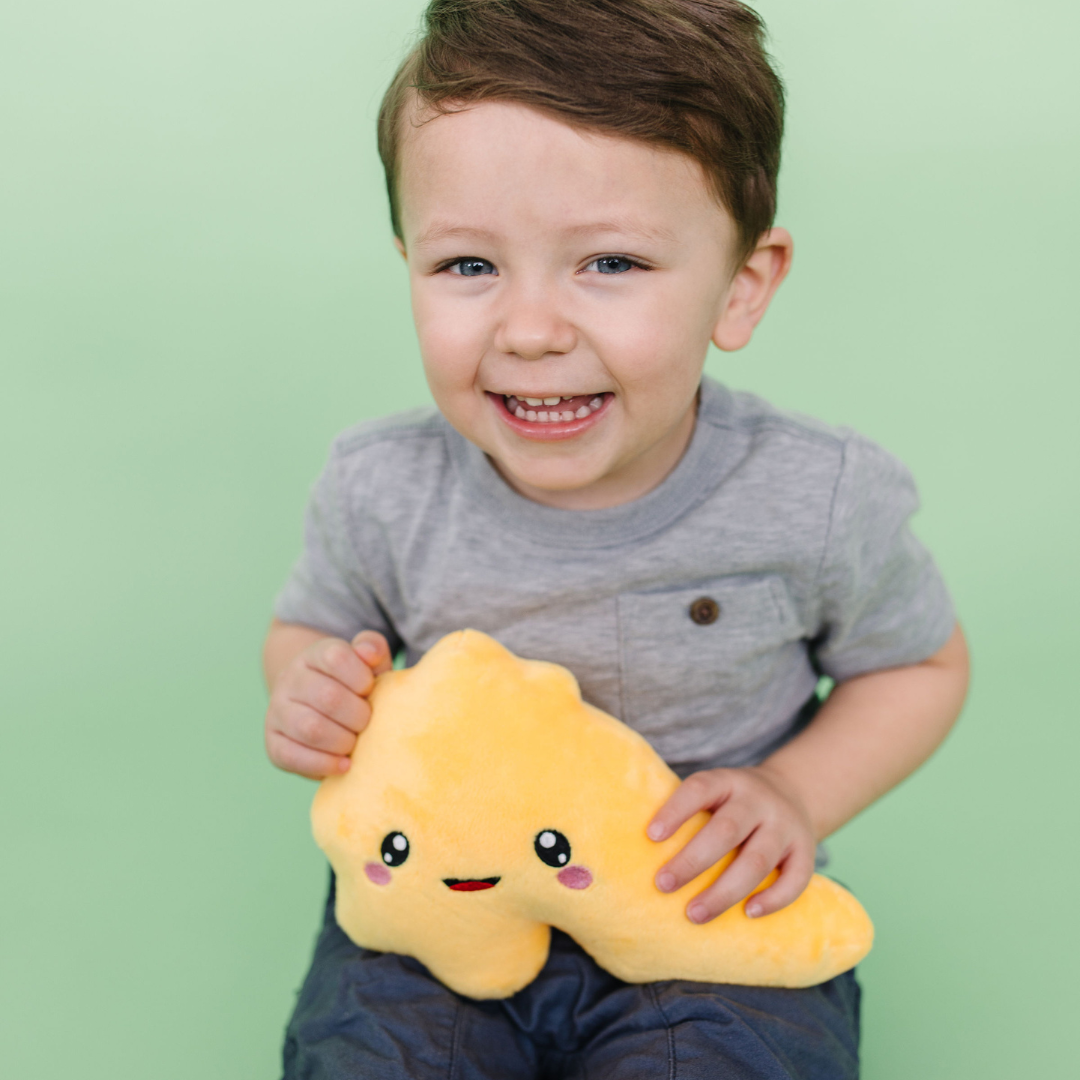 Smiling little boy holding nerdbugs pancreas plush organ