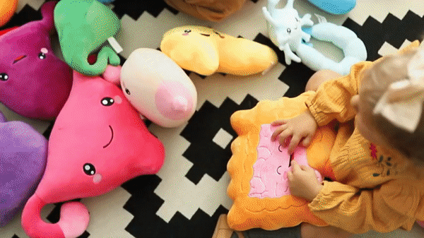 GIF of different people playing various organ toy plushies.
