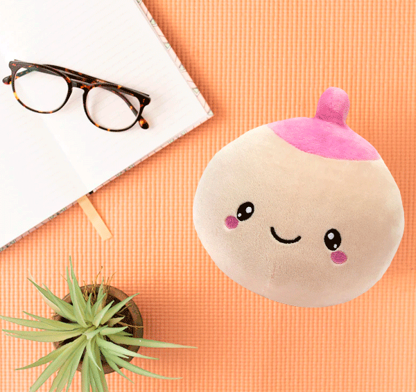 ivory breast toy plushie surrounded with plant notebook and eyelass
