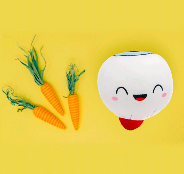 An eye organ toy plushie in yellow background with carrots on the side