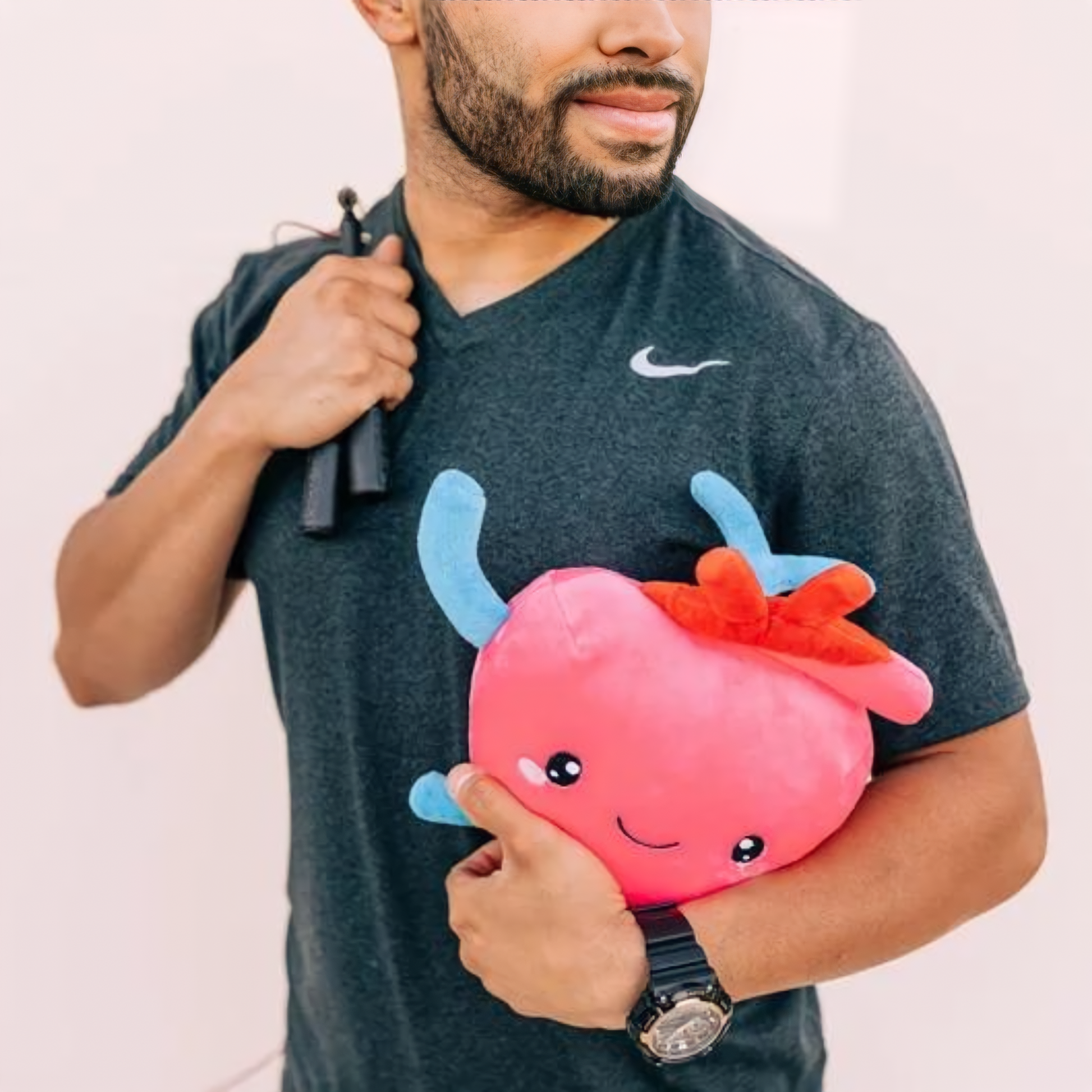 man holding a heart toy plushie