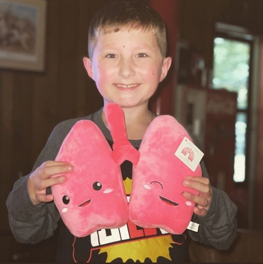 Little Boy Holding a Nerdbugs Lung Plushie Organ