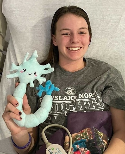 Teenage Girl holding a Nerdbugs Neuron Organ Plushie
