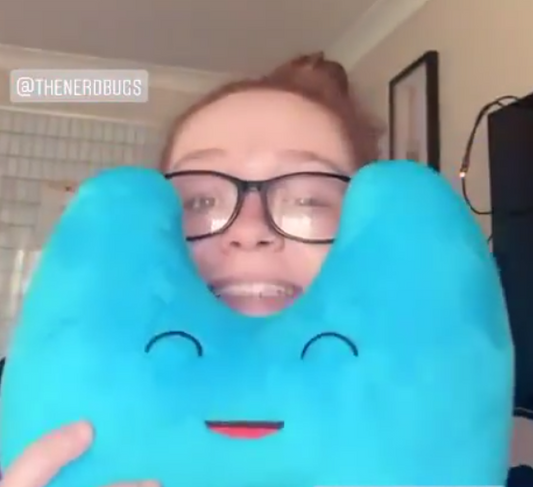 Lady holding a Nerdbugs Thyroid Plushie Organ