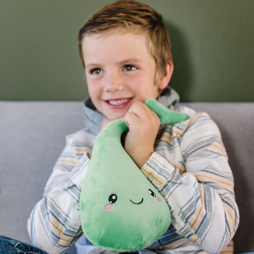 smiling little boy holding a nerdbugs gallbladder plush organ