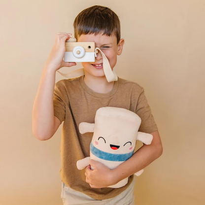 Boy holding a toy camera and spine toy plushie